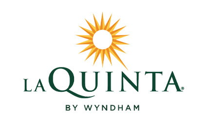 La Quinta by Wyndham logo with a yellow sunburst, perfect after Wahoo's Adventures rafting.