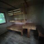 A wooden cabin interior with bunk beds, like cozy treehouse cabins near Boone NC.